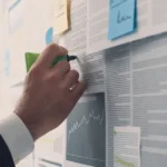 Operations team processing cases manually across multiple screens in a service company office